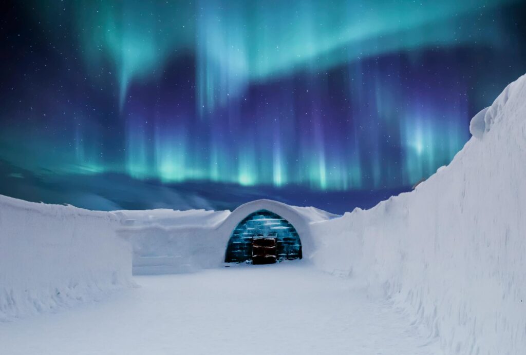 Glass igloo under the Northern Lights in Lapland, Finland – A mesmerizing aurora display illuminating the Arctic night sky.